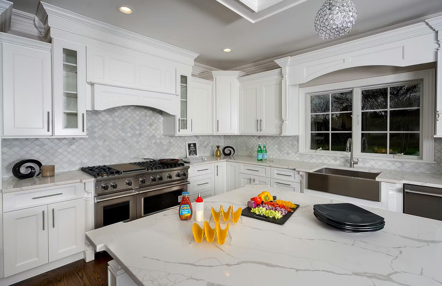 White kitchen with professional range and marble countertops
